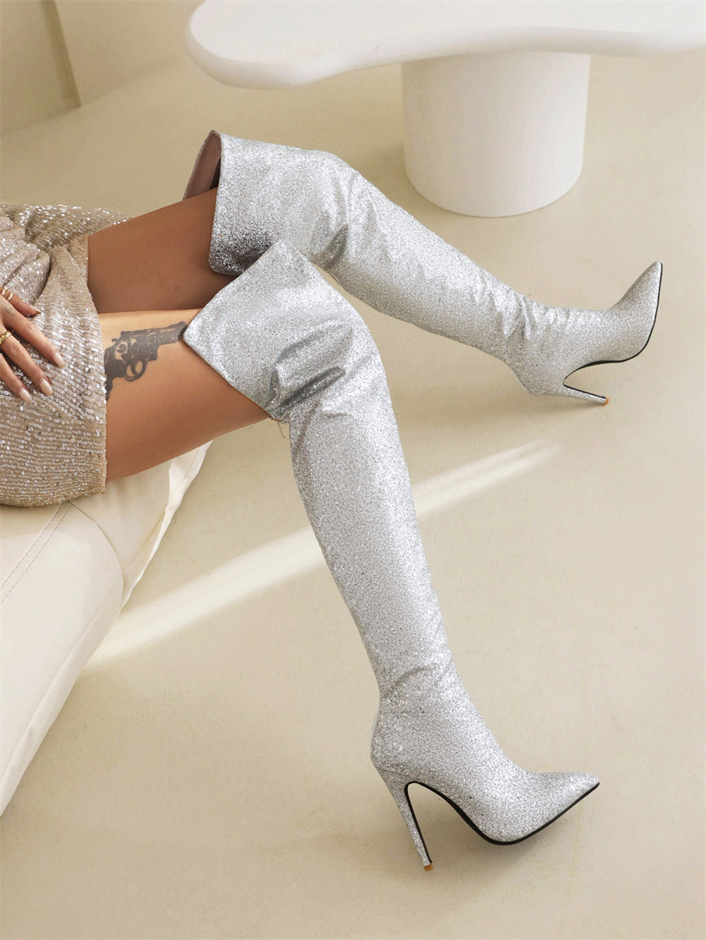 Over-the-knee boots with pointed toe stiletto heels and silver glitter