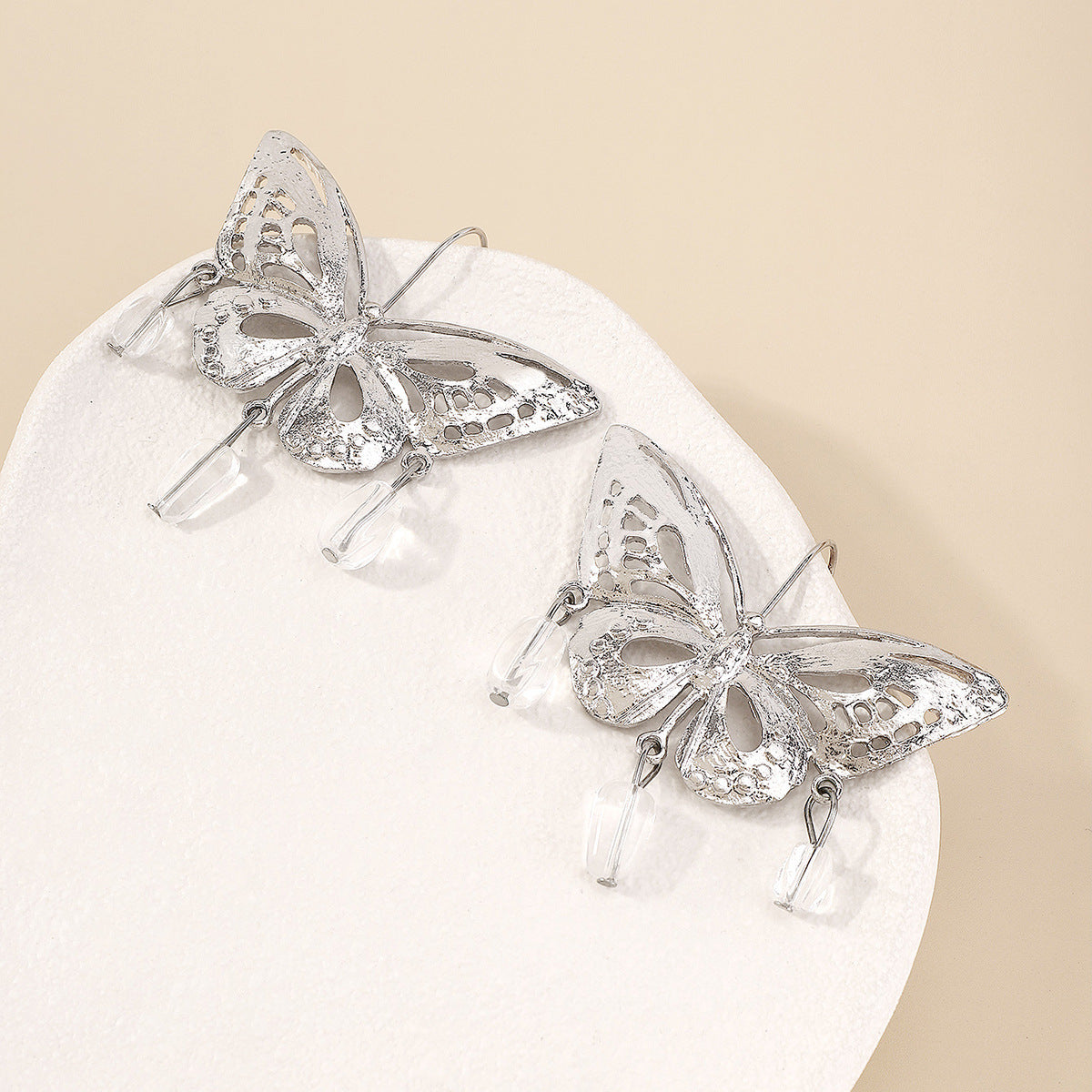 Silver hollow-out butterfly pendant earrings